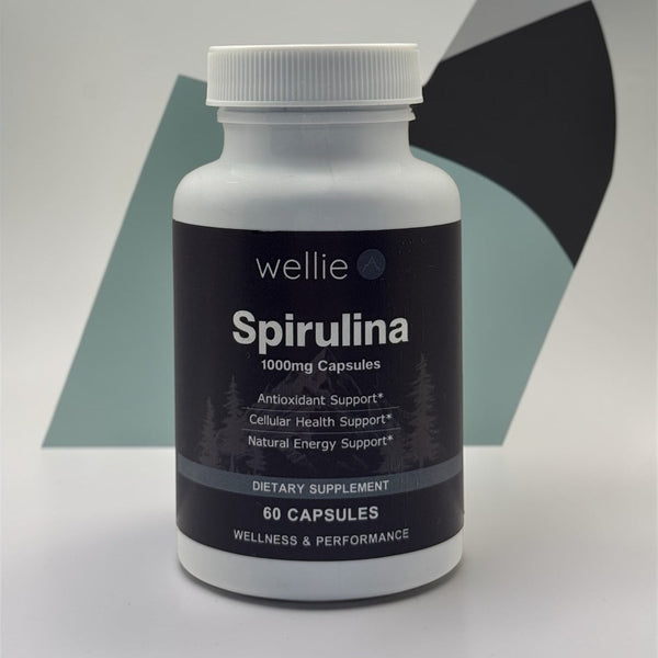 Bottle of Wellie Spirulina capsules on a gray background